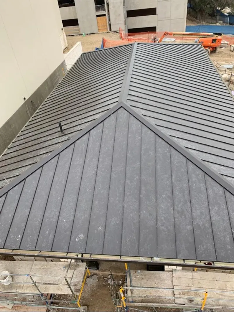 Commercial metal roof construction with crane equipment in Norfolk