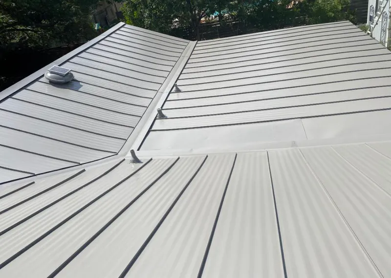 Solar attic fan installed on a metal roof for Roof Ventilation in Norfolk